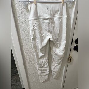 White 7/8 length lululemons with slight pink stain on leg.